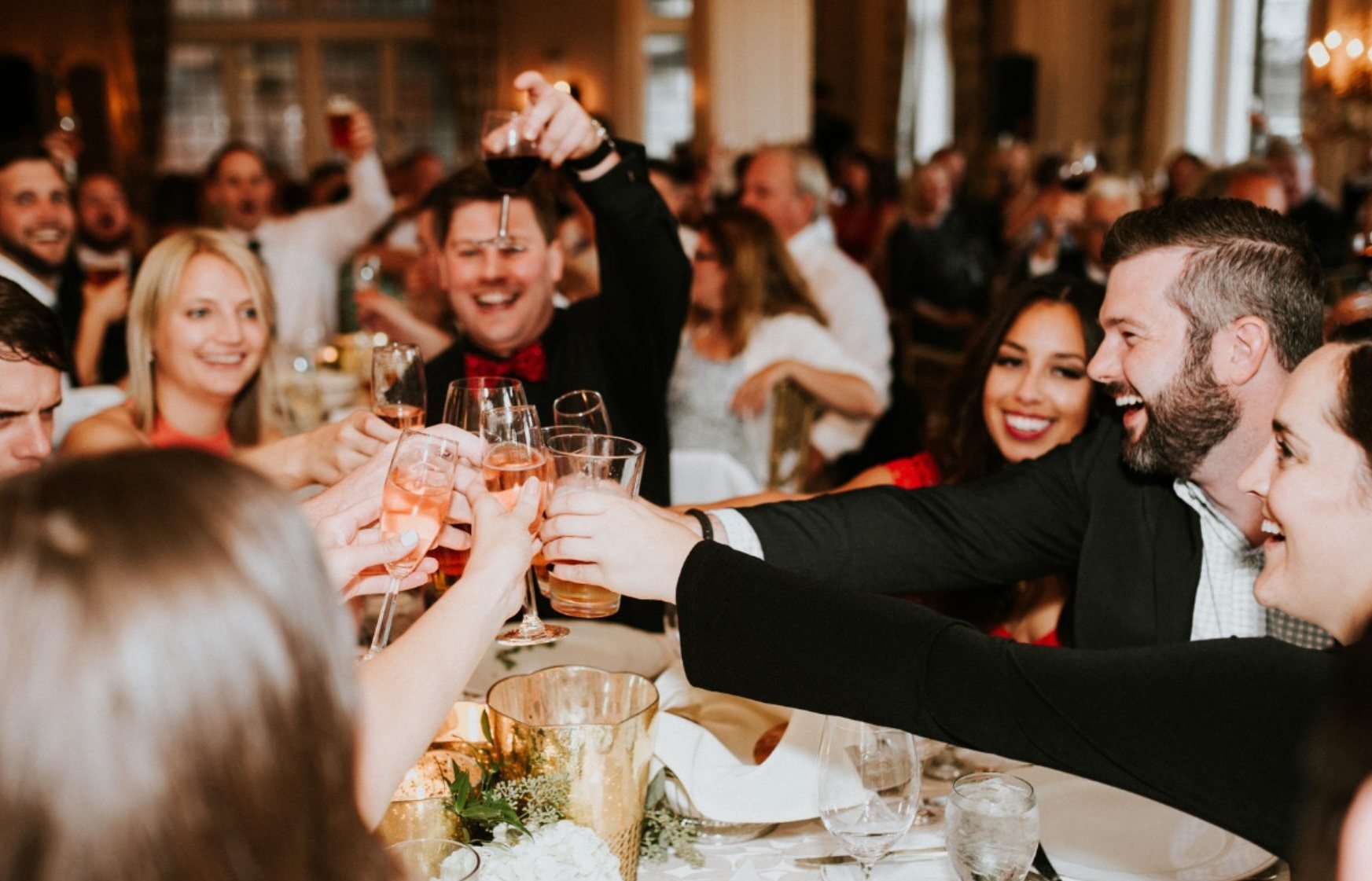 Members raising a toast at a crowded dinner in the Club's ballroom