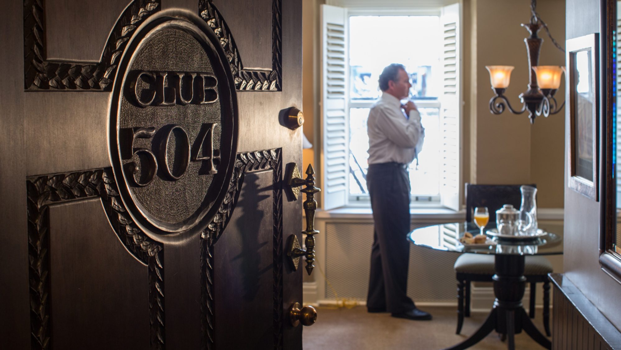 The door to Club suite 504, with a Member standing by the window inside